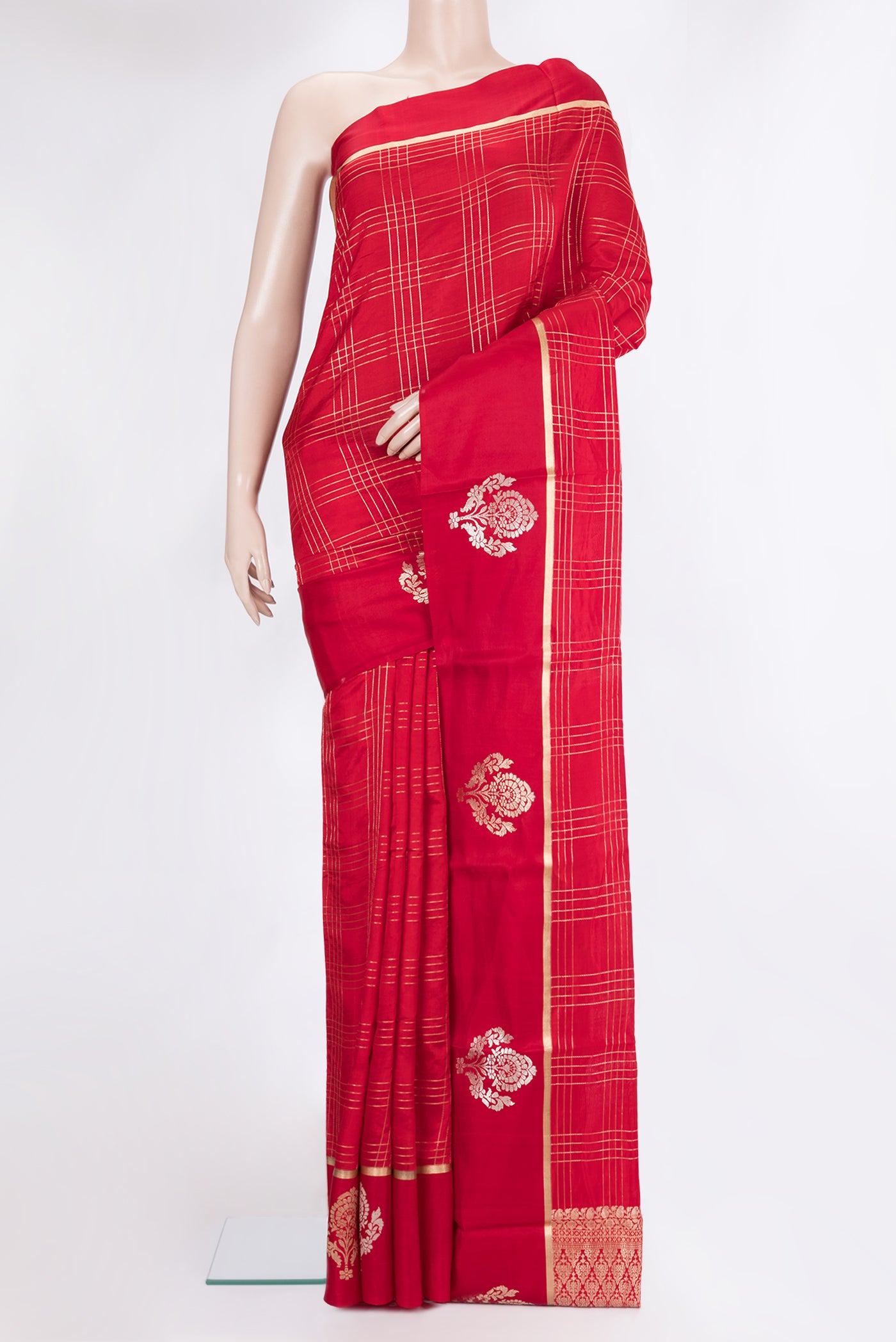 Red Tussar Silk Saree with Checked design on the body and Fancy Border.  displayed on a mannequin