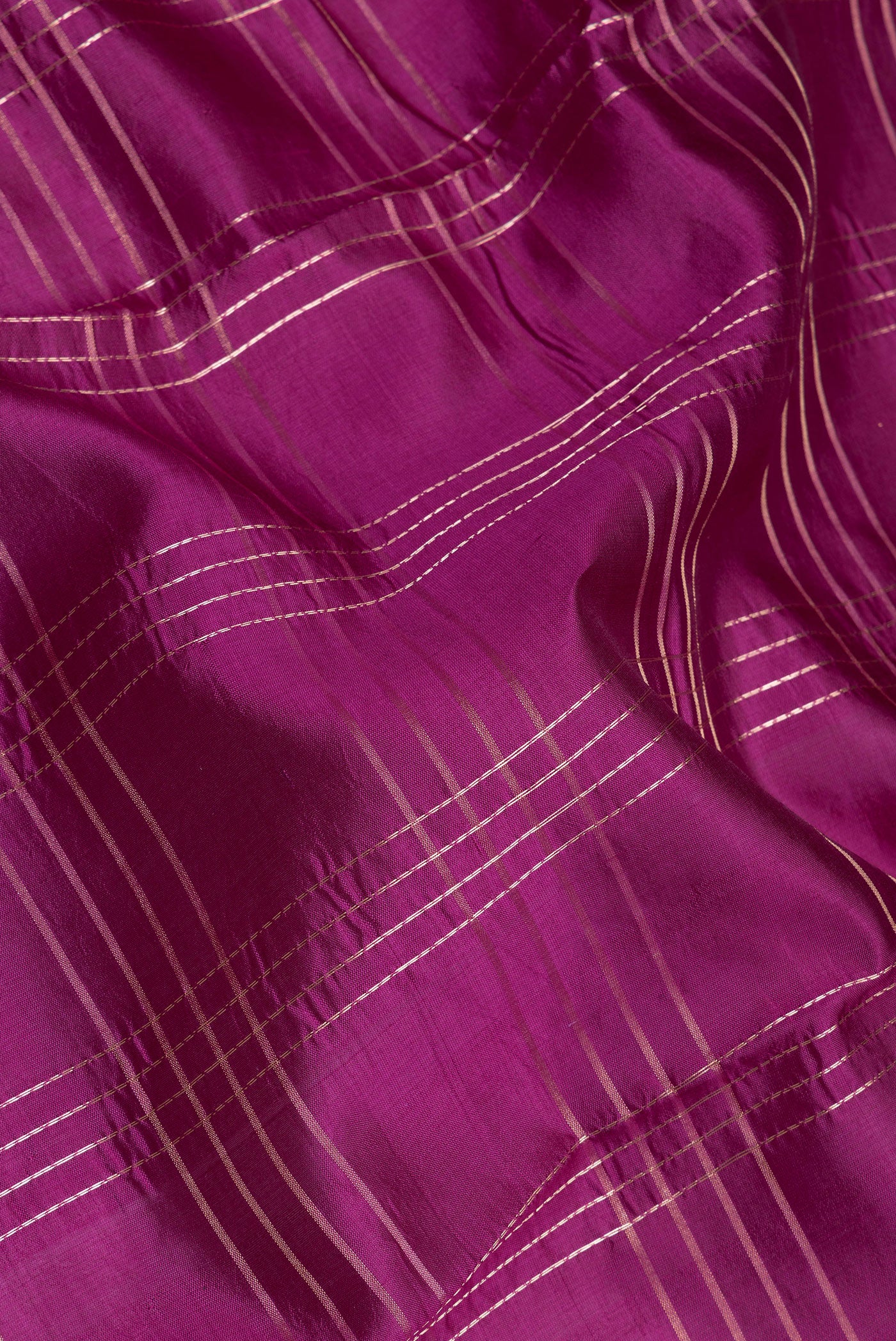 Close up of Purple Tussar Silk Saree with Checked design on the body and Fancy Border.  displaying folds