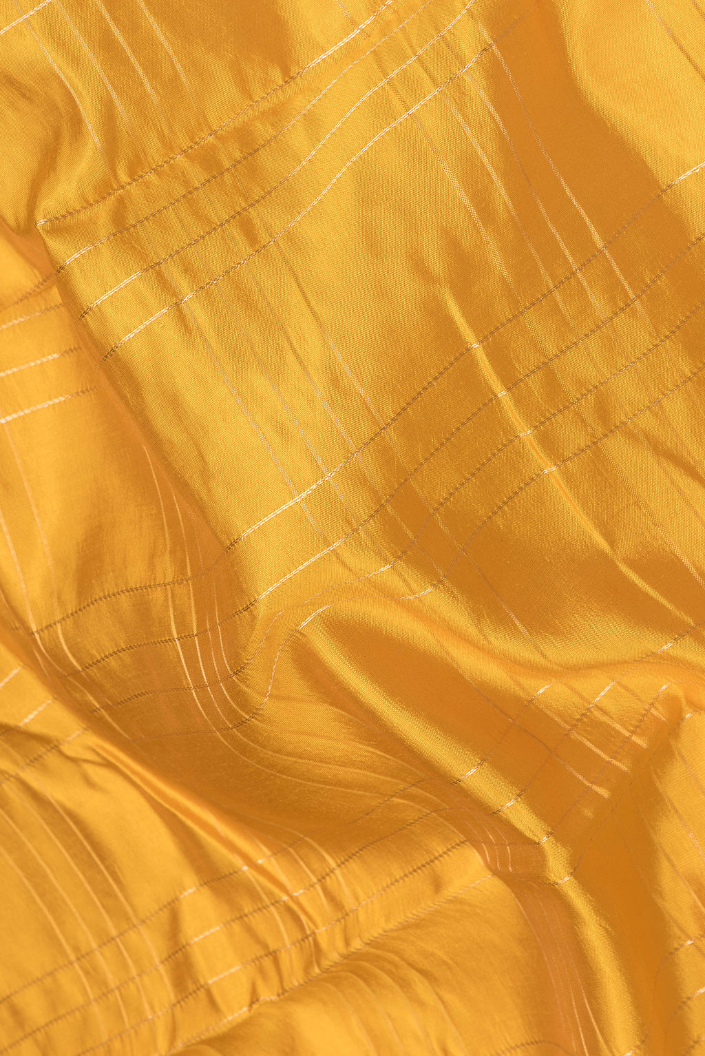 Close up of Yellow Tussar Silk Saree with Checked design on the body and Fancy Border.  displaying folds