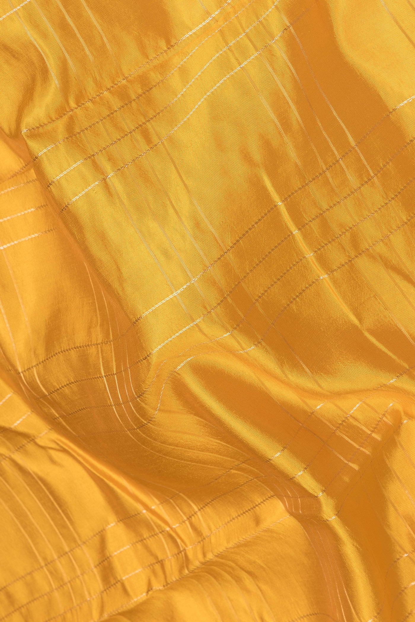 Close up of Yellow Tussar Silk Saree with Checked design on the body and Fancy Border.  displaying folds