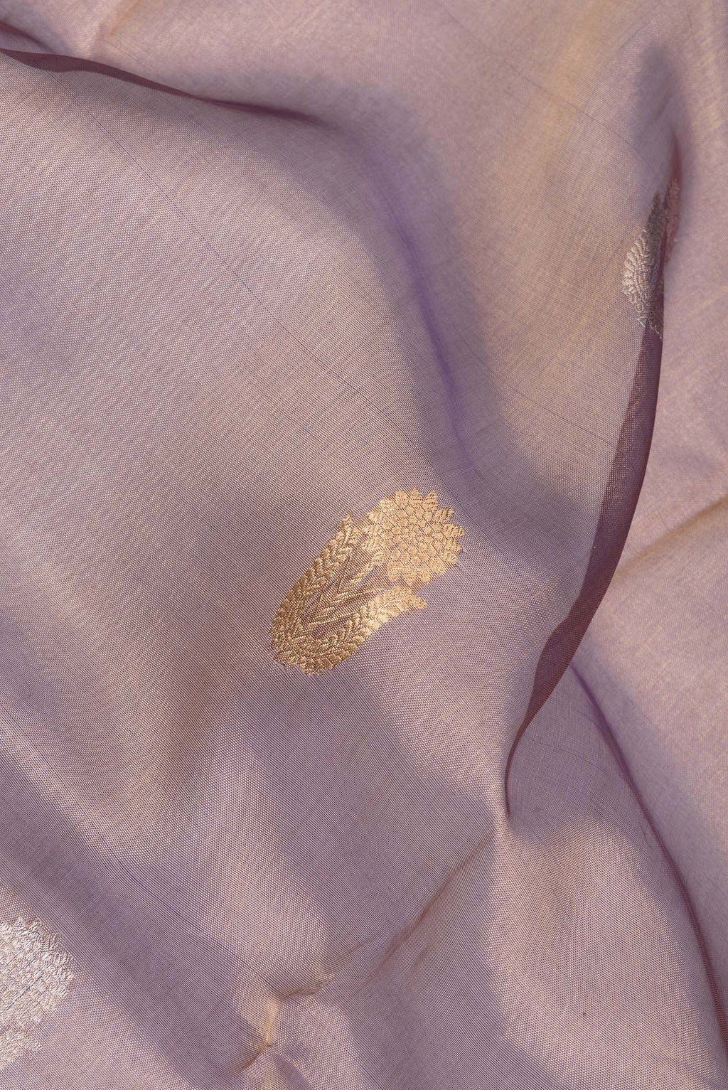 Close up of Purple Dual Tone Organza Saree with Zari Butta on the body and Zari Border.  displaying folds