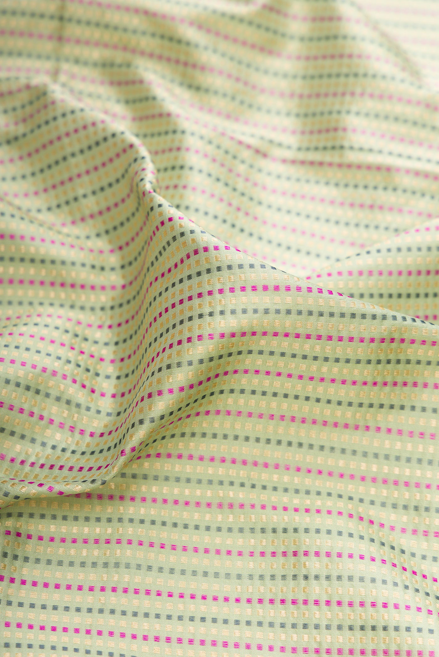 Close up of Pista Green Banarasi Silk Saree with Stripes on the body and Fancy Border.  displaying folds