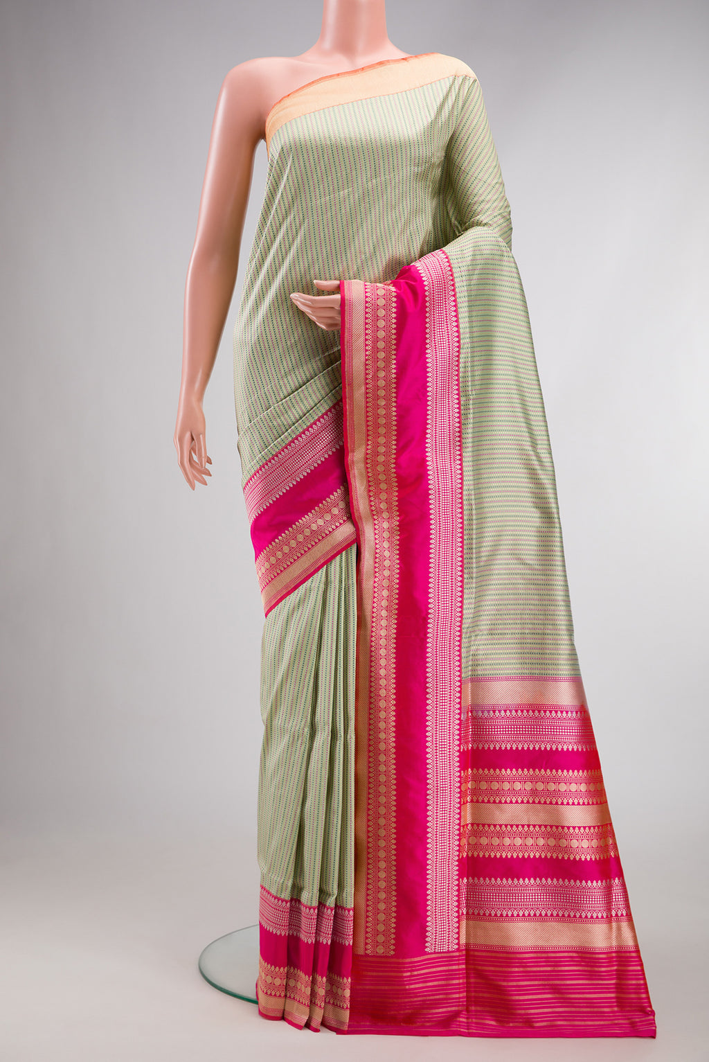 Pista Green Banarasi Silk Saree with Stripes on the body and Fancy Border.  displayed on a mannequin
