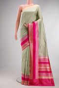 Pista Green Banarasi Silk Saree with Stripes on the body and Fancy Border.  displayed on a mannequin
