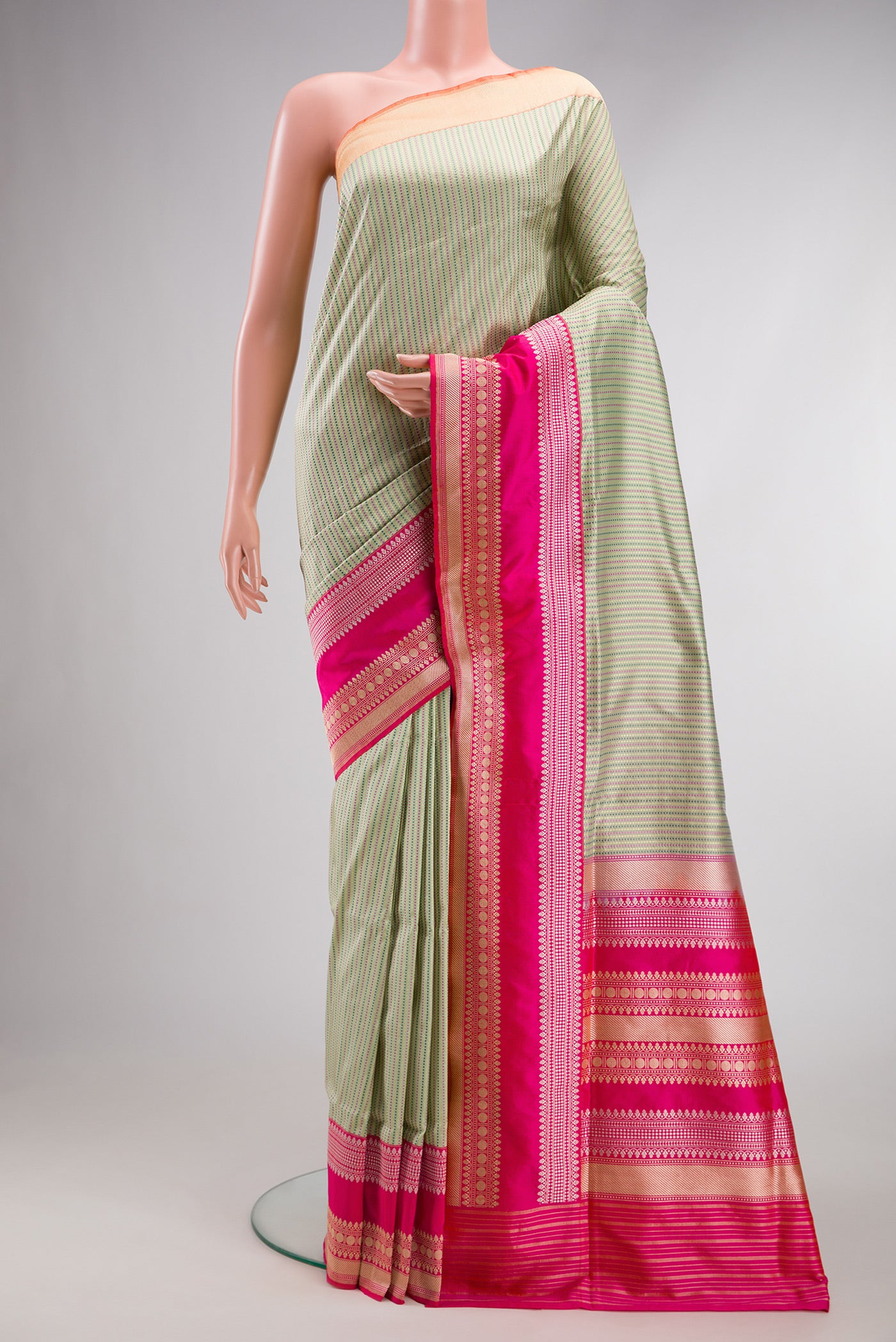 Pista Green Banarasi Silk Saree with Stripes on the body and Fancy Border.  displayed on a mannequin