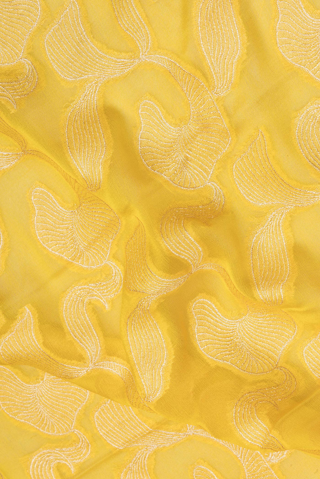 Close up of Yellow Banarasi Georgette Saree with Zari Brocade on the body and Zari Border.  displaying folds