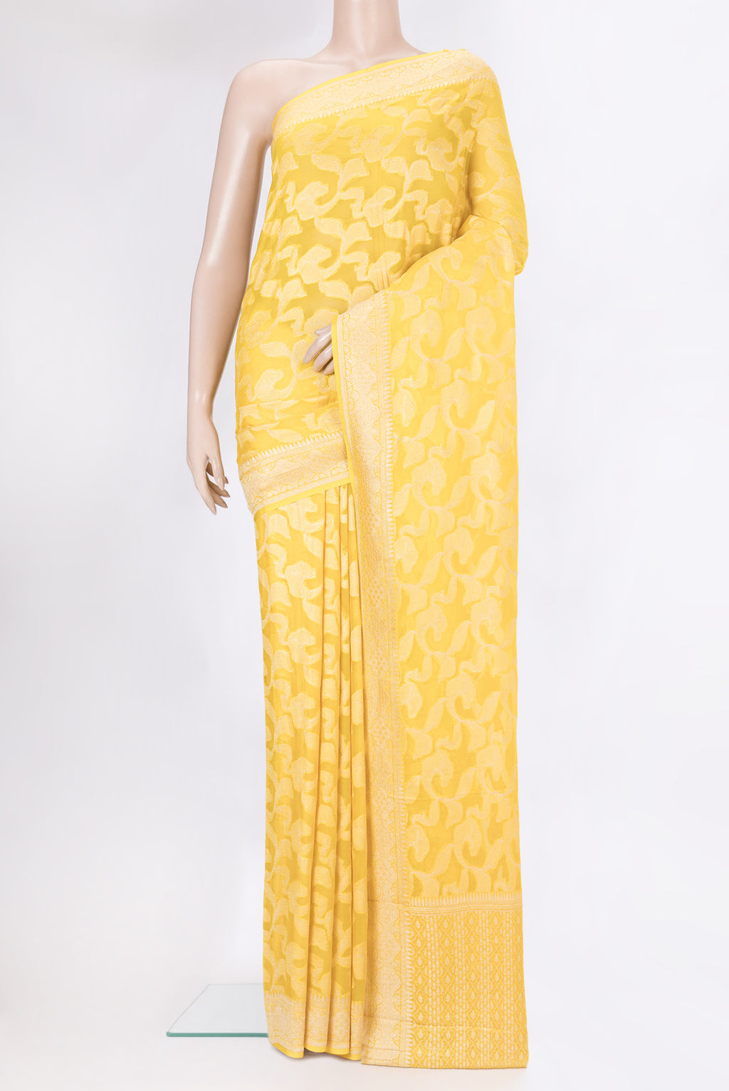 Yellow Banarasi Georgette Saree with Zari Brocade on the body and Zari Border.  displayed on a mannequin