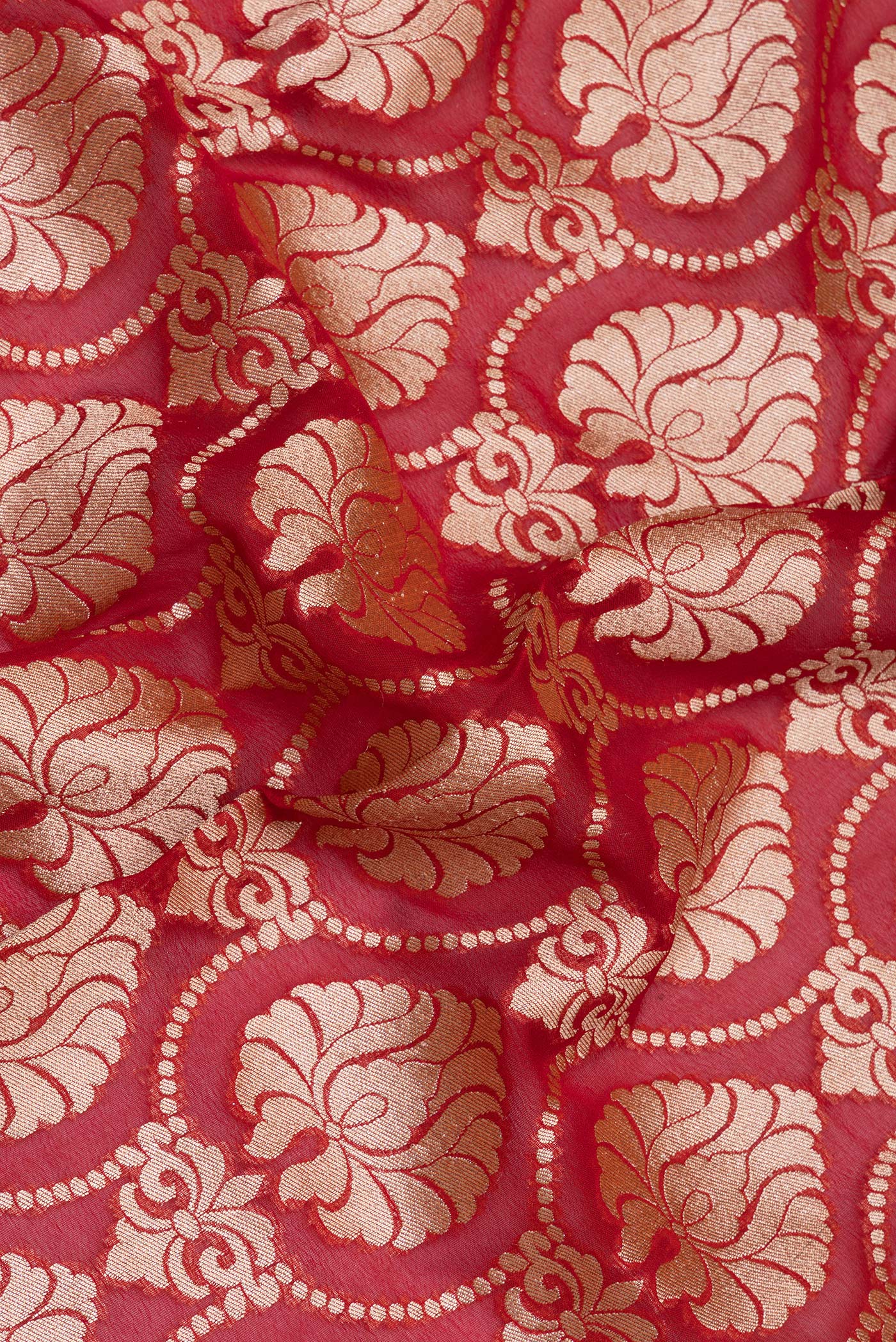 Close up of Red Banarasi Georgette Saree with Zari Brocade on the body and Zari Border.  displaying folds