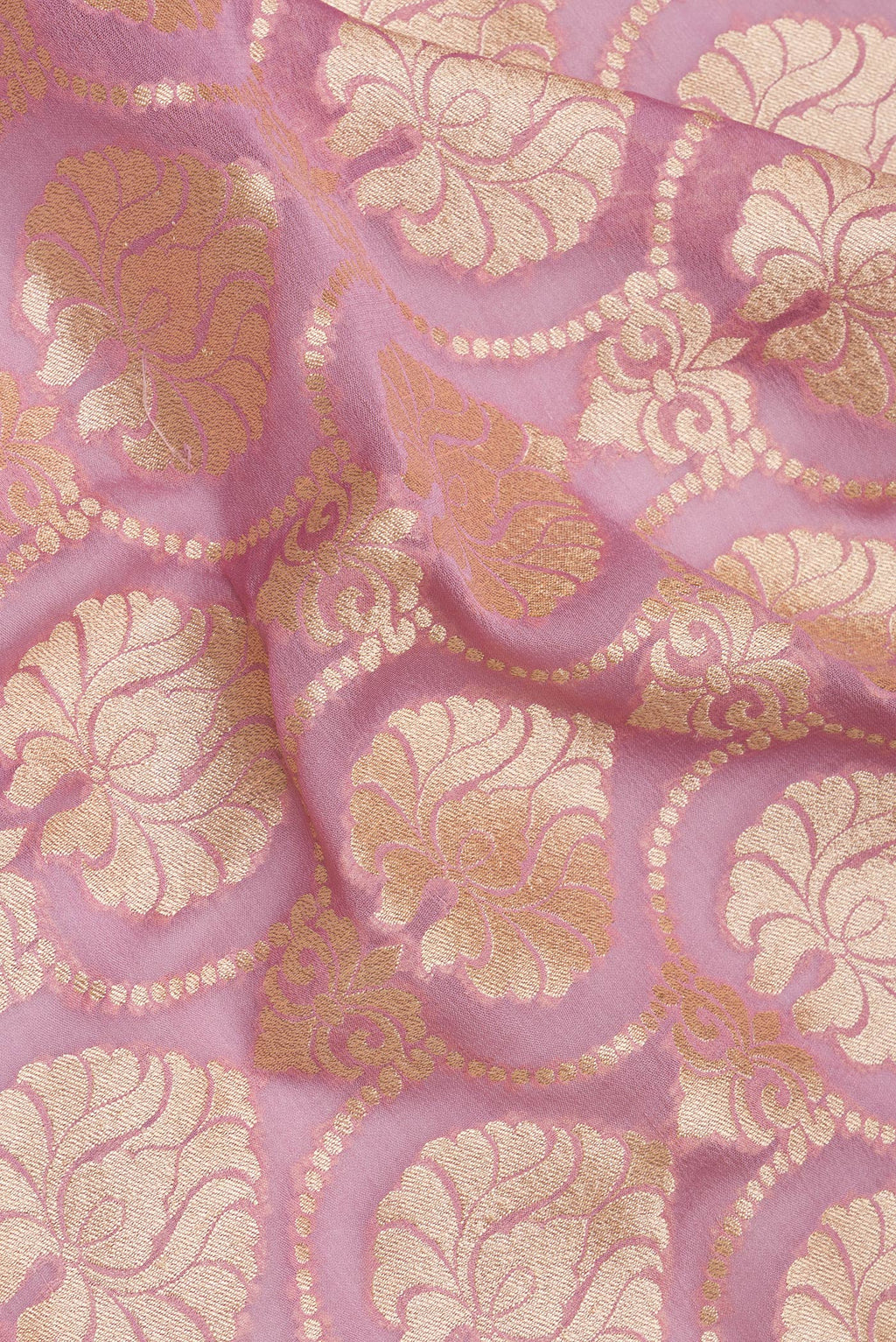 Close up of Rose pink Banarasi Georgette Saree with Zari Brocade on the body and Zari Border.  displaying folds