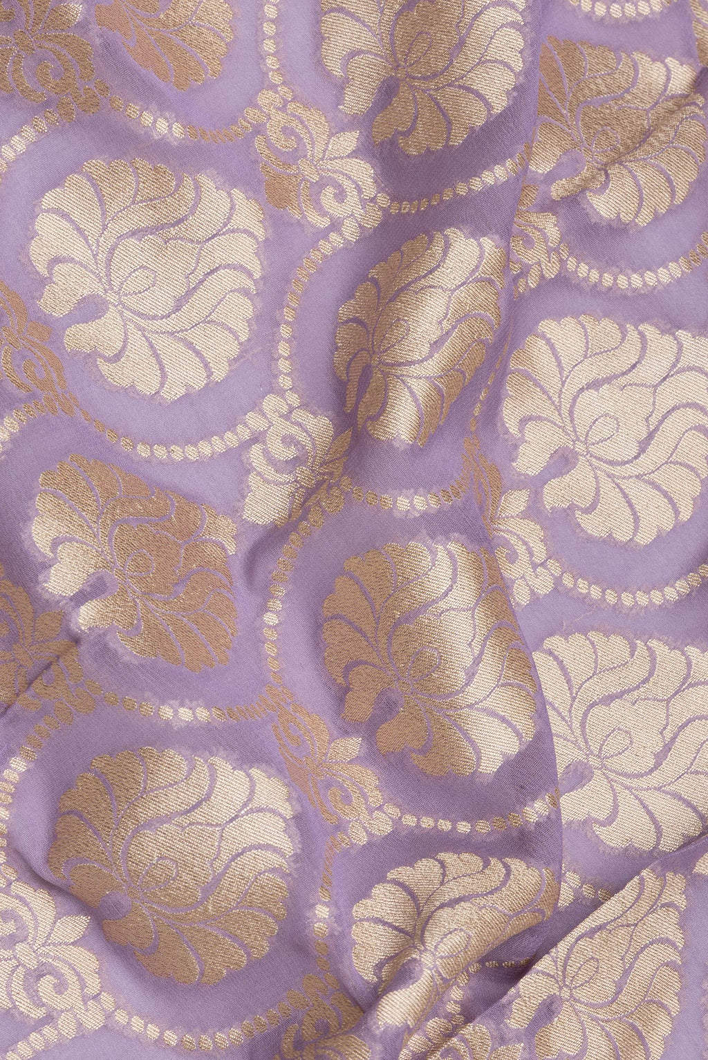 Close up of Lavender Banarasi Georgette Saree with Zari Brocade on the body and Zari Border.  displaying folds