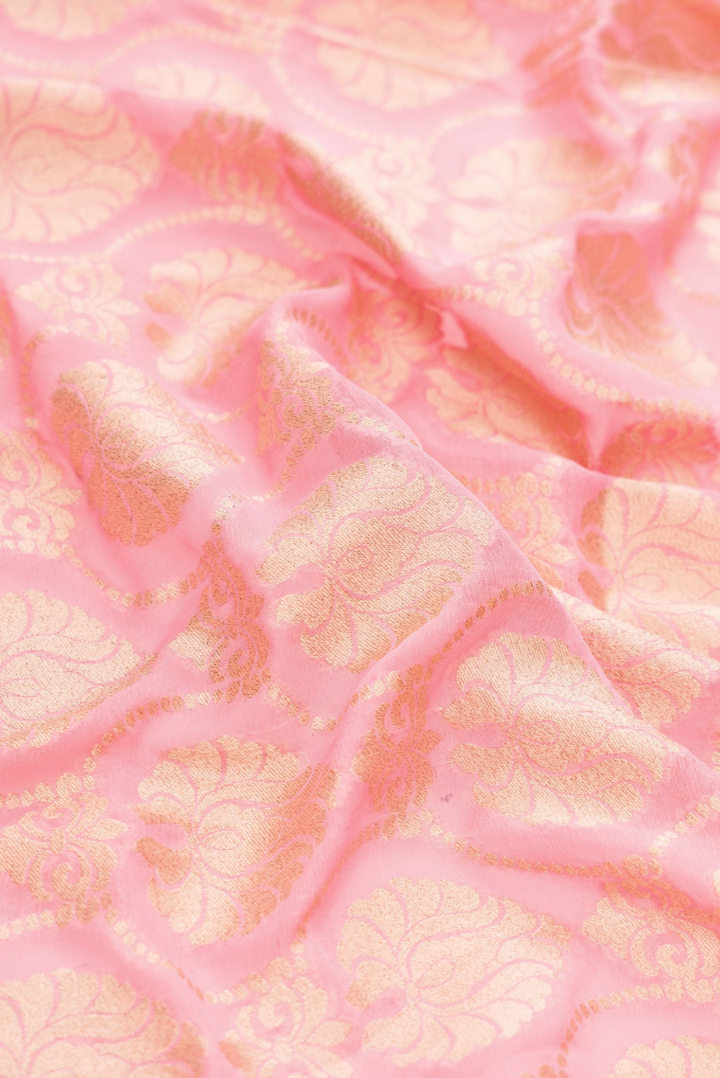 Close up of Pink Banarasi Georgette Saree with Zari Brocade on the body and Fancy Border.  displaying folds