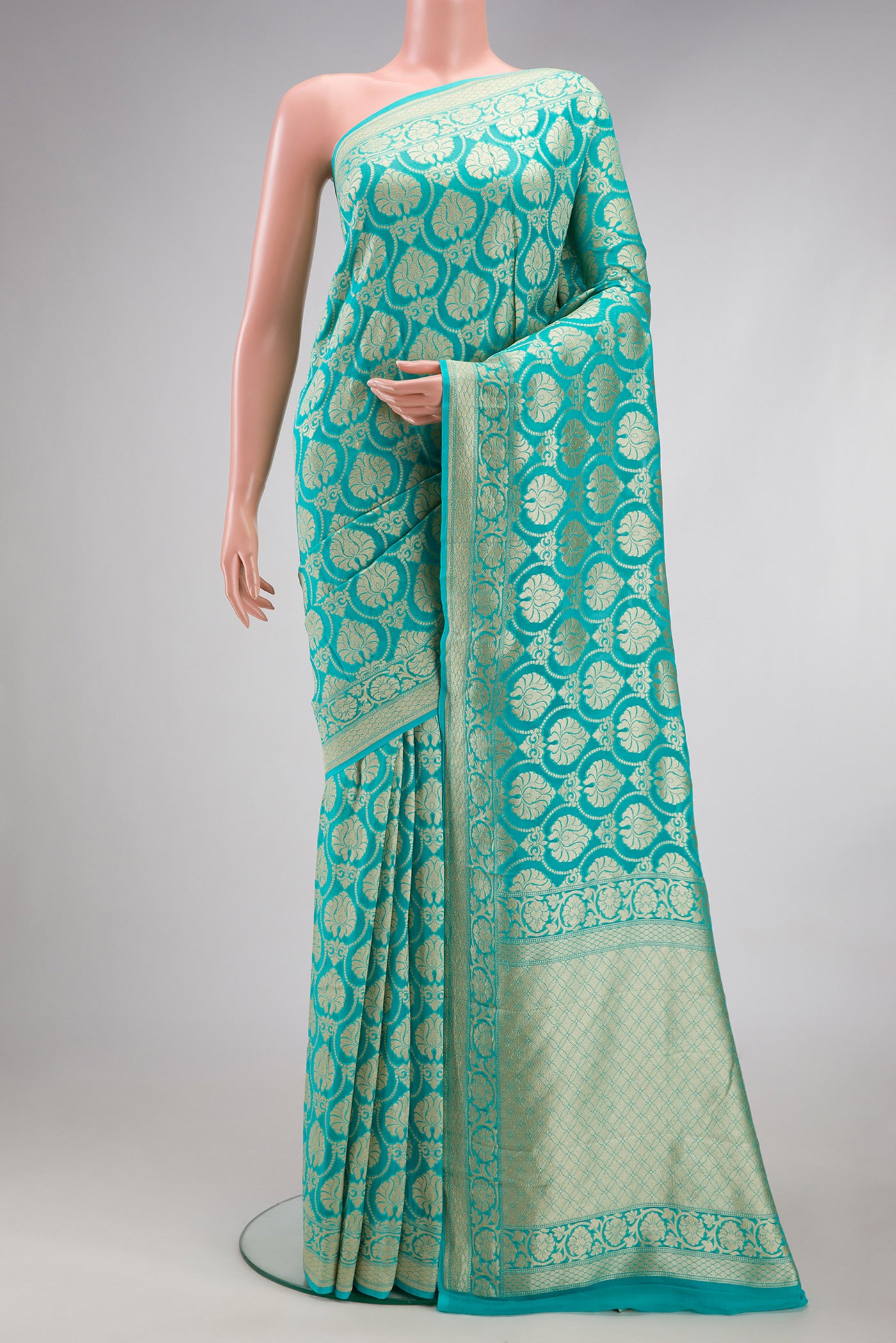 Sky Blue Banarasi Georgette Saree with Zari Brocade on the body and Fancy Border.  displayed on a mannequin