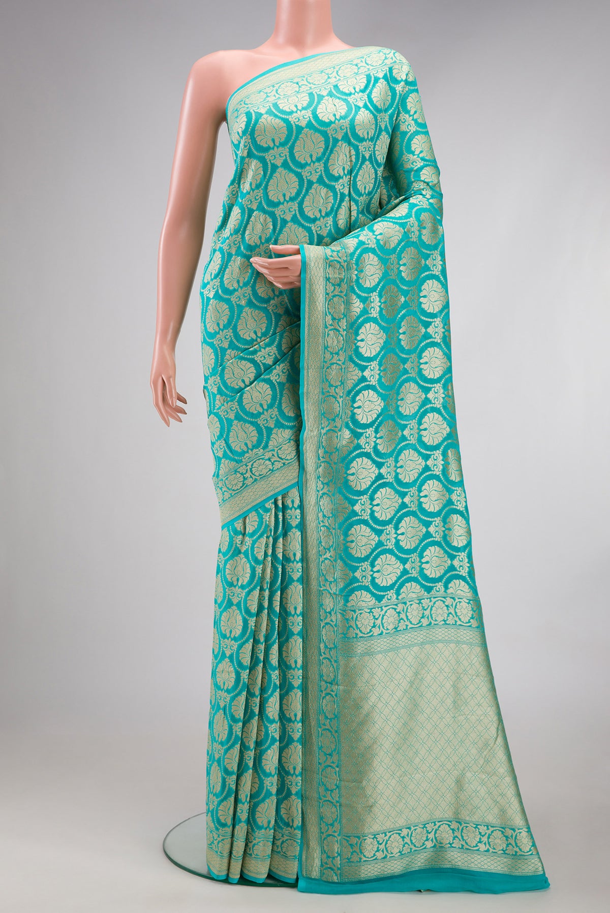 Sky Blue Banarasi Georgette Saree with Zari Brocade on the body and Fancy Border.  displayed on a mannequin