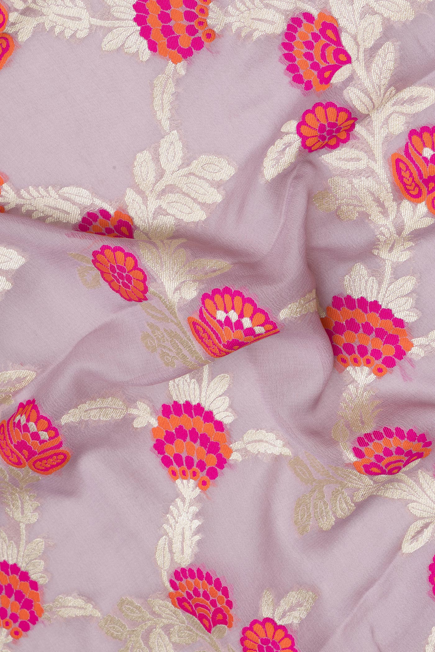 Close up of Lavender Banarasi Georgette Saree with Zari And Thread Butta on the body and Fancy Border.  displaying folds