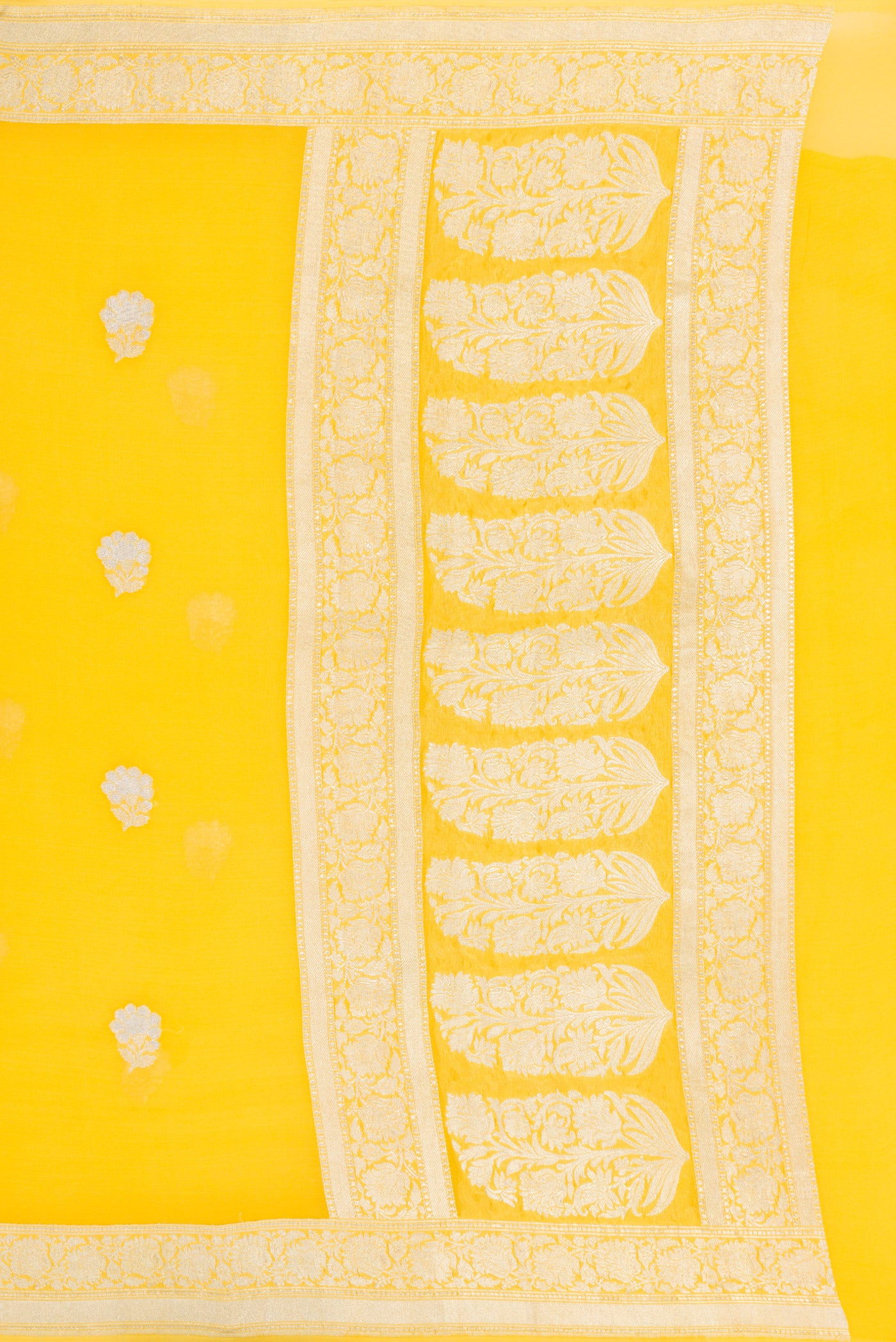 Close up image of the pallu of Yellow Banarasi Georgette Saree with Zari Butta on the body and Zari Border. 