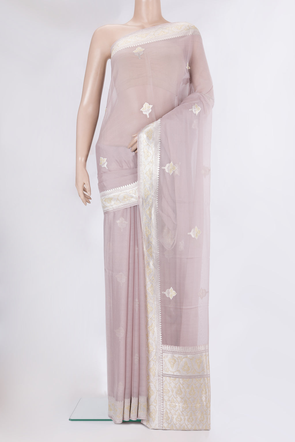 Rose Gold Banarasi Georgette Saree with Zari Butta on the body and Zari Border.  displayed on a mannequin