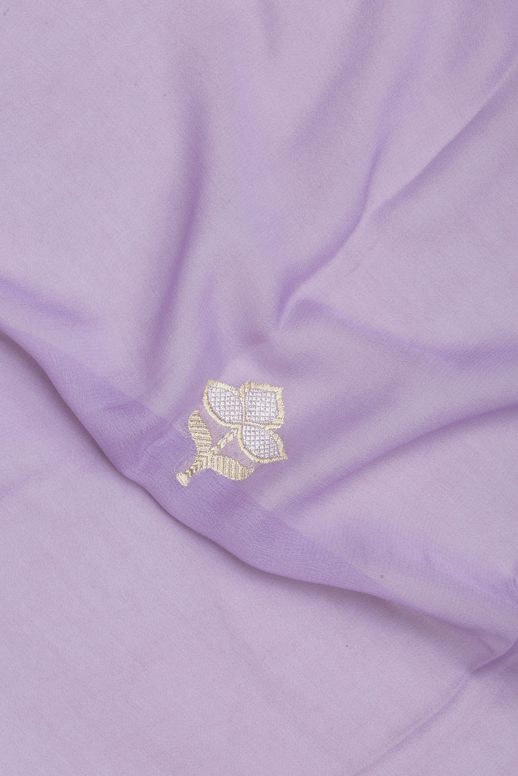 Close up of Lavender Banarasi Georgette Saree with Zari Butta on the body and Fancy Border.  displaying folds