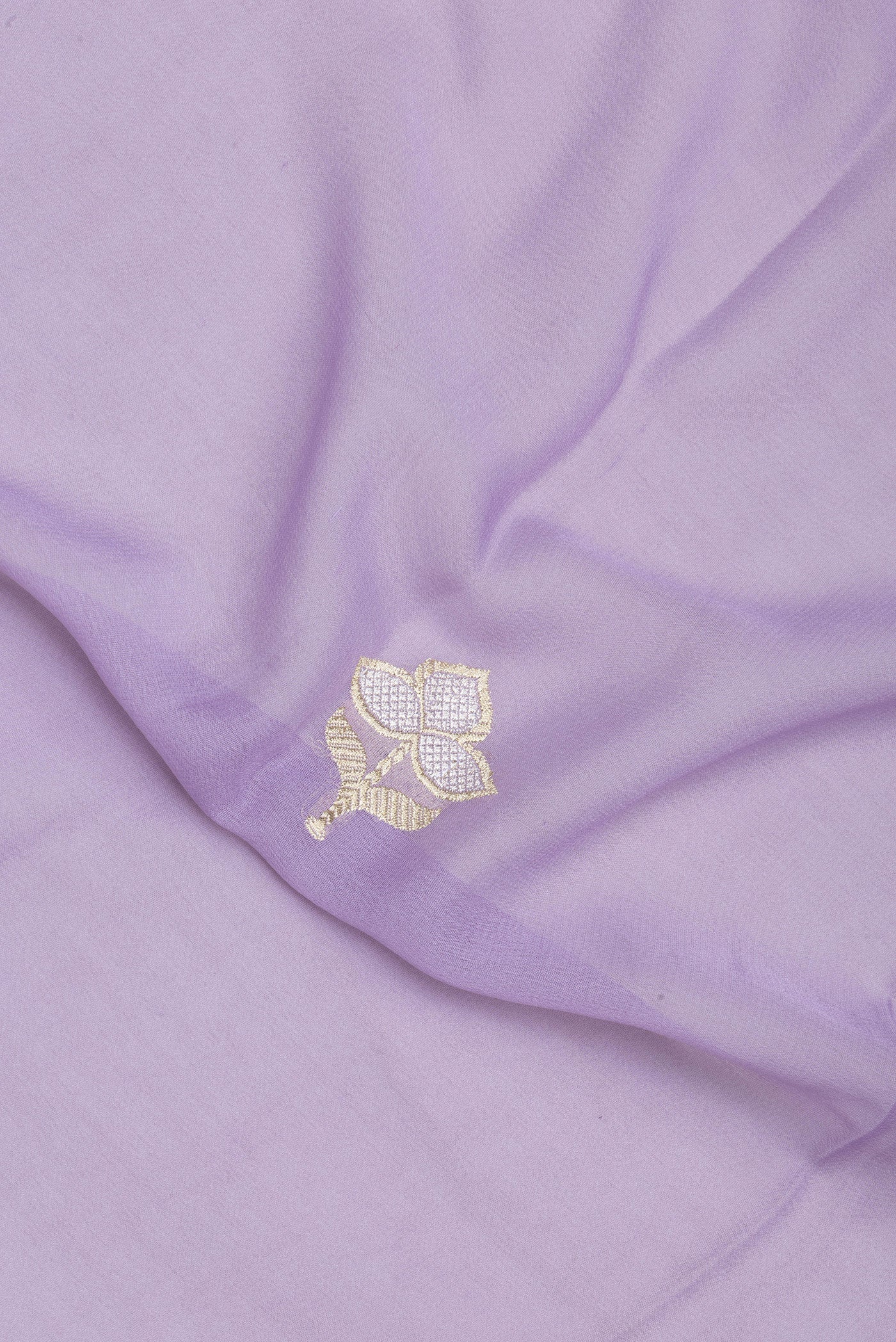 Close up of Lavender Banarasi Georgette Saree with Zari Butta on the body and Fancy Border.  displaying folds