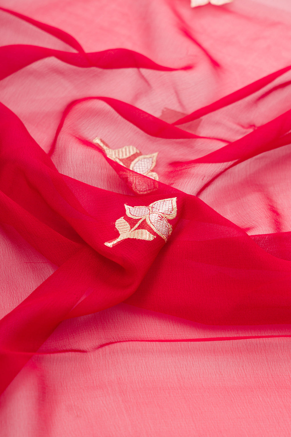 Close up of Red Banarasi Georgette Saree with Zari Butta on the body and Zari Border.  displaying folds