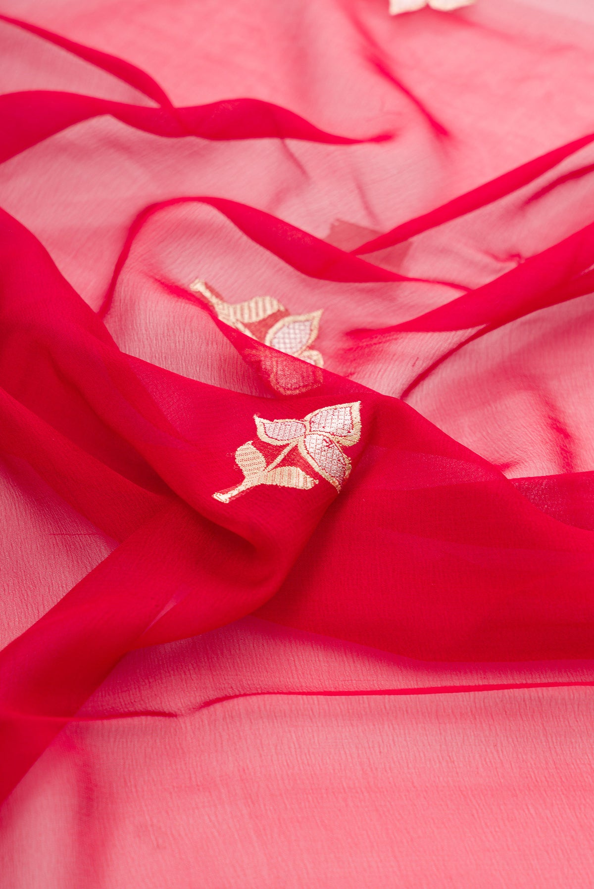Close up of Red Banarasi Georgette Saree with Zari Butta on the body and Zari Border.  displaying folds