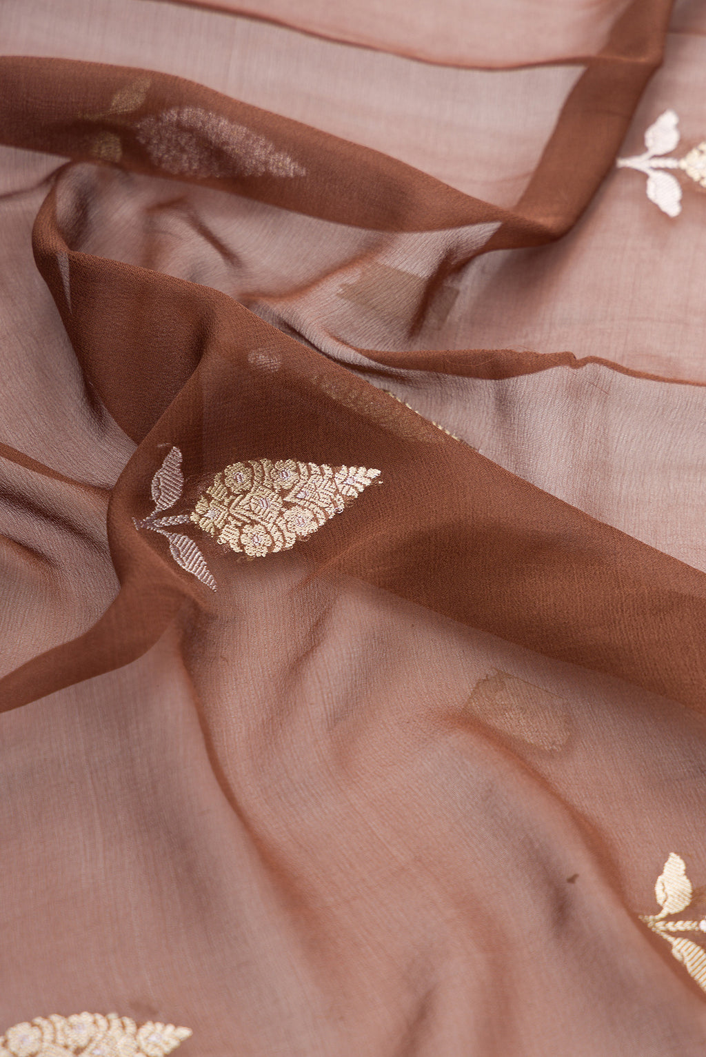 Close up of Brown Banarasi Georgette Saree with Zari Butta on the body and Fancy Border.  displaying folds