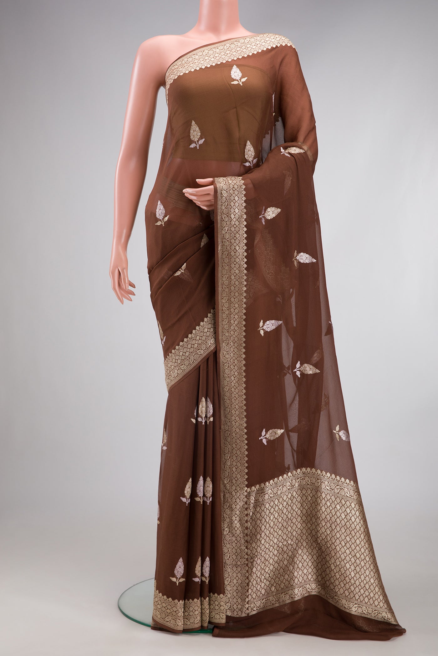 Brown Banarasi Georgette Saree with Zari Butta on the body and Fancy Border.  displayed on a mannequin