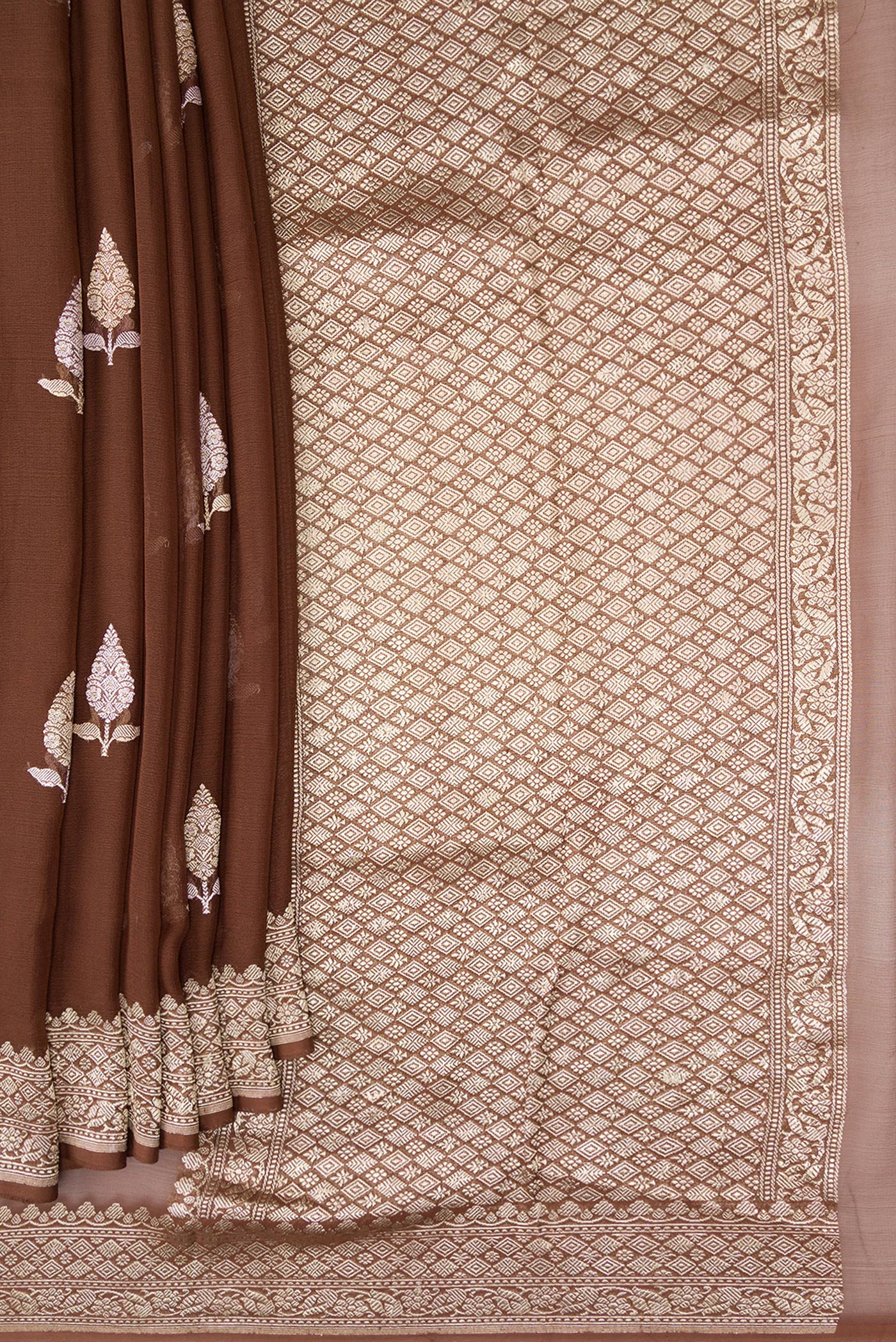 Pleats and pallu of Brown Banarasi Georgette Saree with Zari Butta on the body and Fancy Border. 