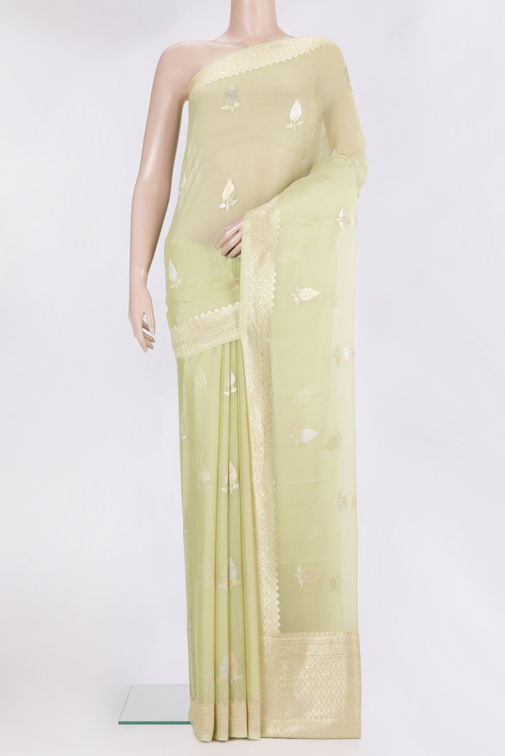 Pista Green Dual Tone Banarasi Georgette Saree with Zari Butta on the body and Fancy Border.  displayed on a mannequin
