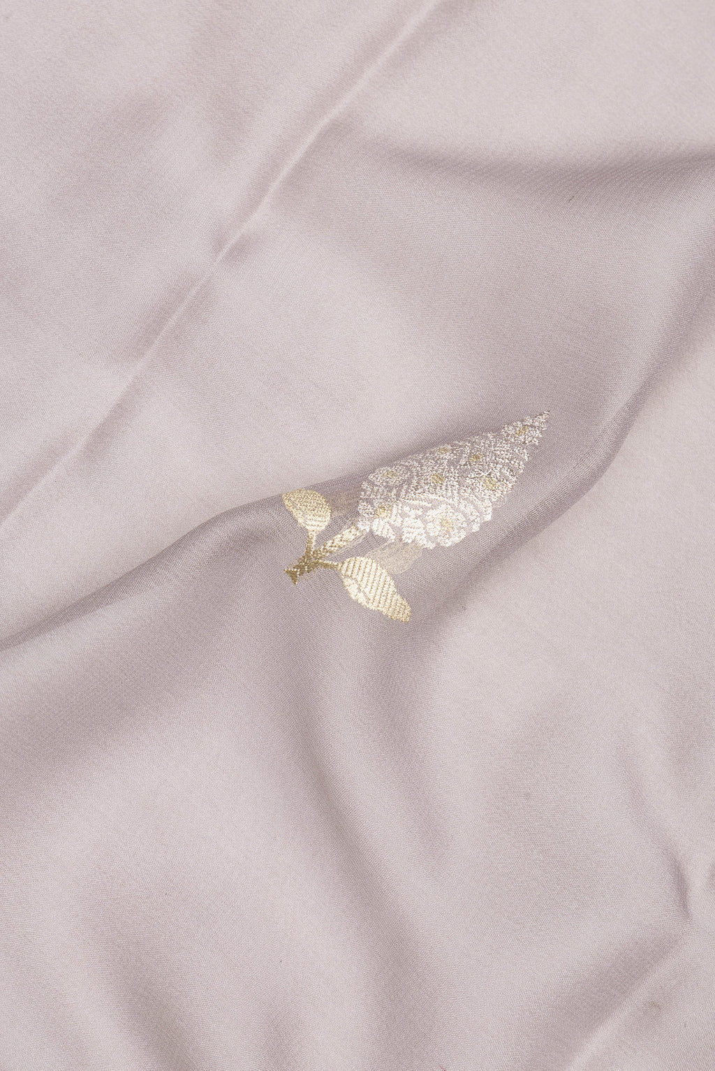 Close up of Grey Banarasi Georgette Saree with Zari Butta on the body and Zari Border.  displaying folds