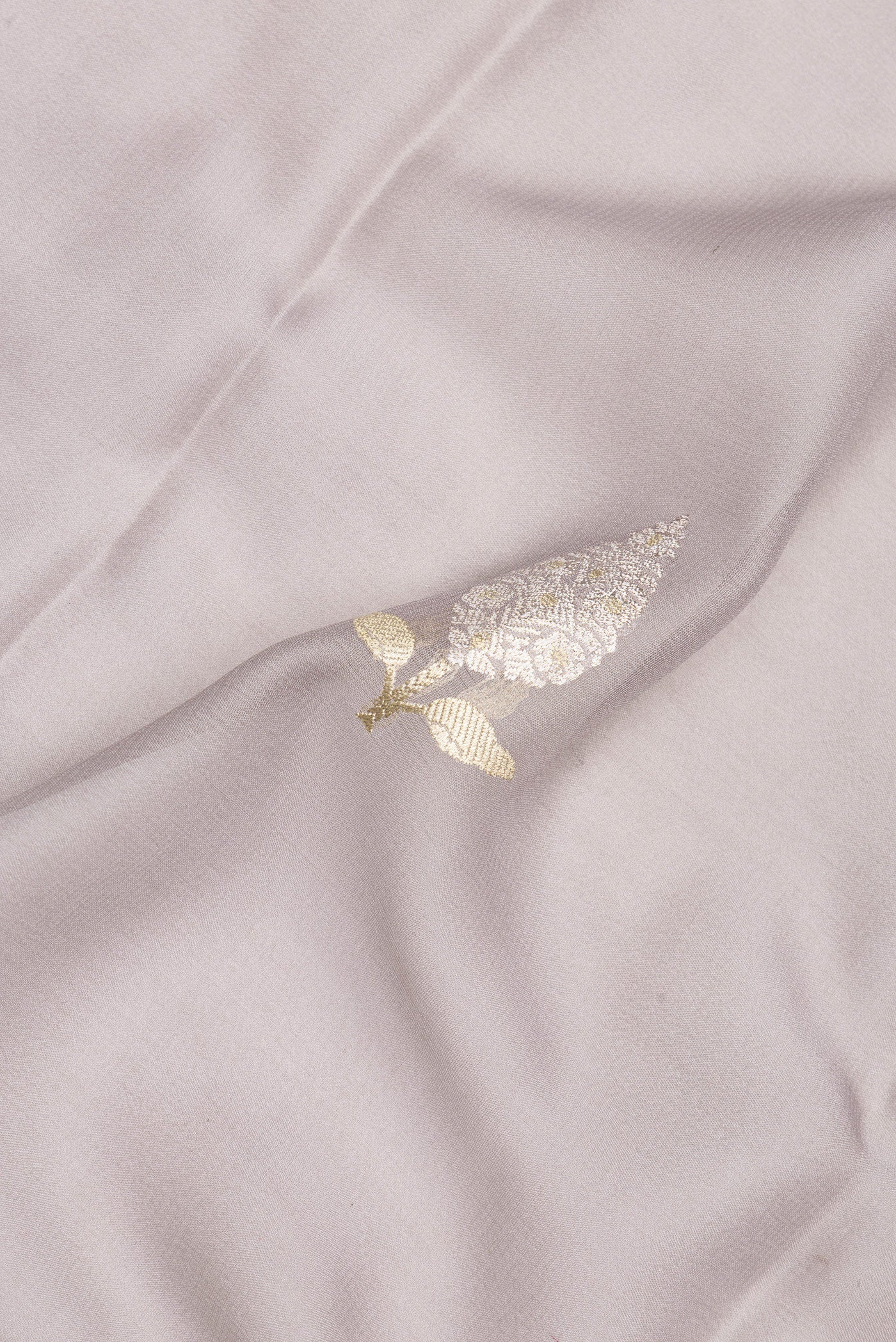 Close up of Grey Banarasi Georgette Saree with Zari Butta on the body and Zari Border.  displaying folds