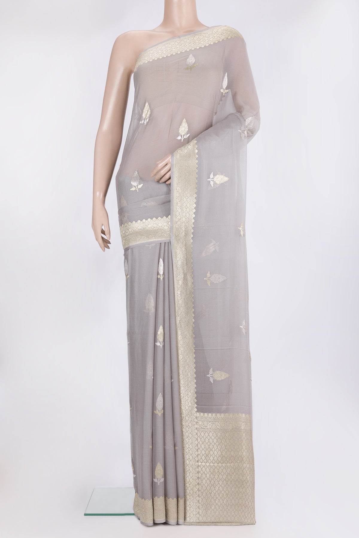 Grey Banarasi Georgette Saree with Zari Butta on the body and Zari Border.  displayed on a mannequin
