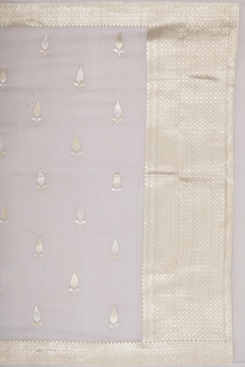 Close up image of the pallu of Grey Banarasi Georgette Saree with Zari Butta on the body and Zari Border. 