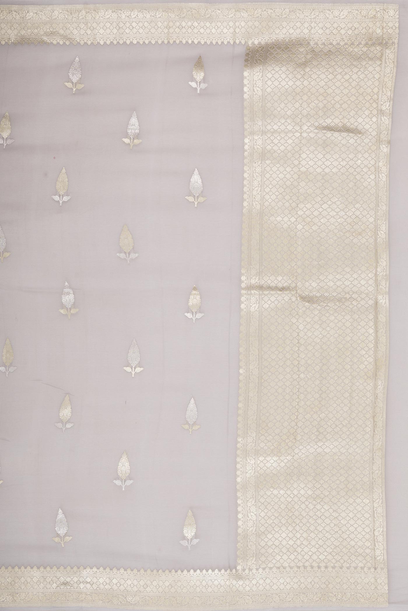 Close up image of the pallu of Grey Banarasi Georgette Saree with Zari Butta on the body and Zari Border. 