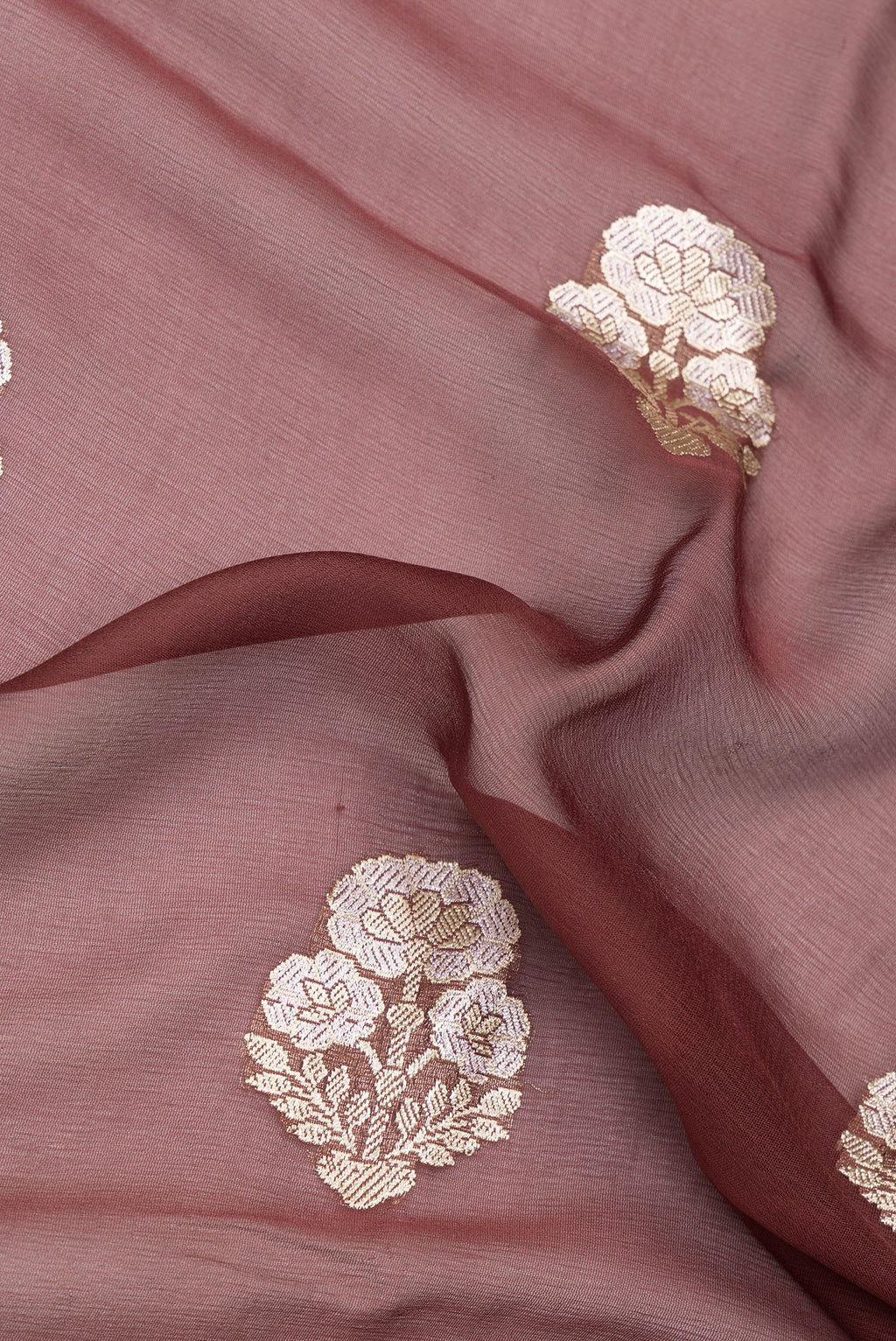 Close up of Brown Banarasi Georgette Saree with Zari Butta on the body and Zari Border.  displaying folds