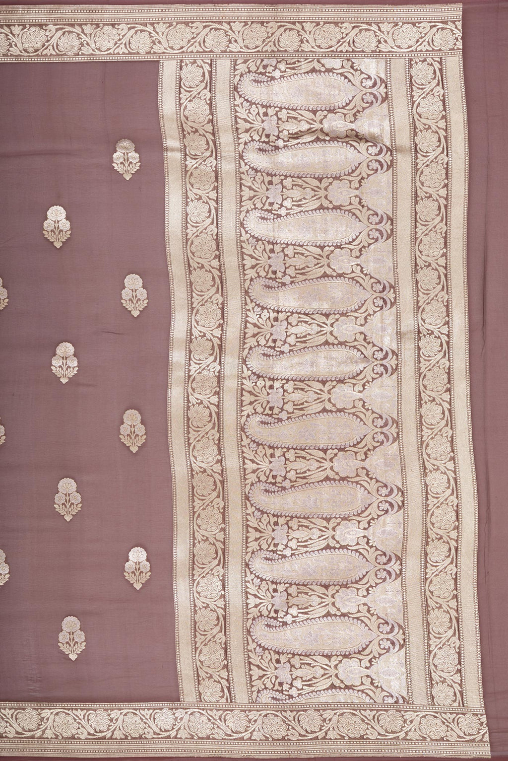 Close up image of the pallu of Brown Banarasi Georgette Saree with Zari Butta on the body and Zari Border. 