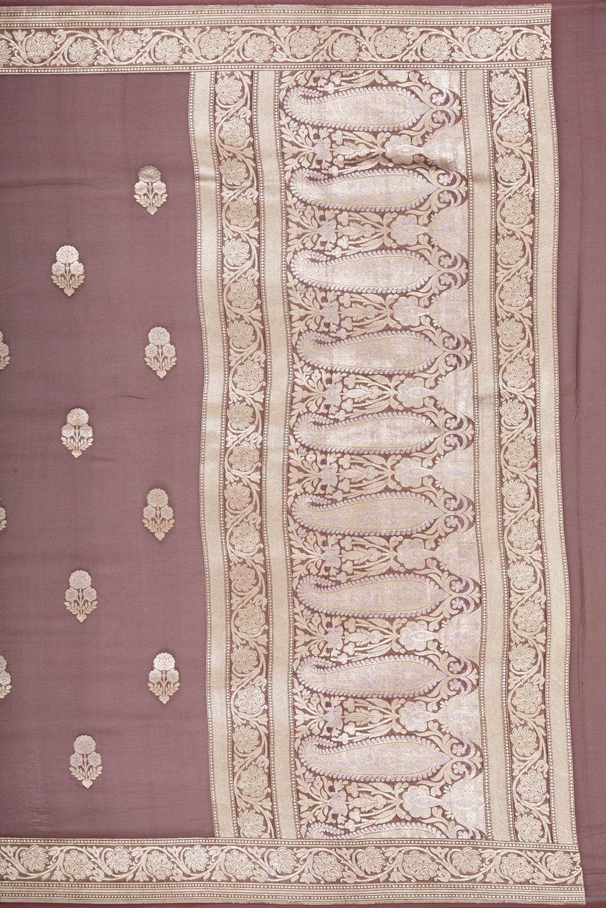 Close up image of the pallu of Brown Banarasi Georgette Saree with Zari Butta on the body and Zari Border. 