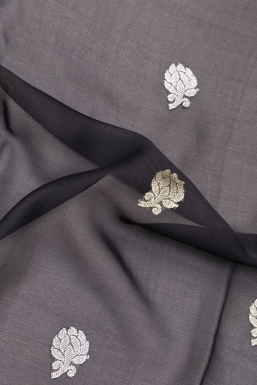 Close up of Black Banarasi Georgette Saree with Zari Butta on the body and Zari Border.  displaying folds