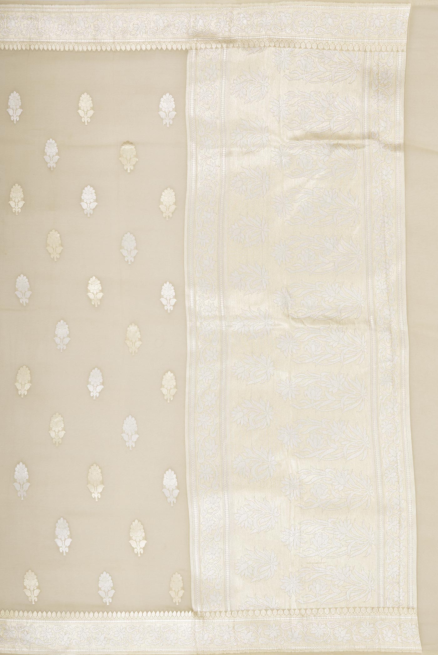 Close up image of the pallu of Beige Banarasi Georgette Saree with Zari Butta on the body and Zari Border. 