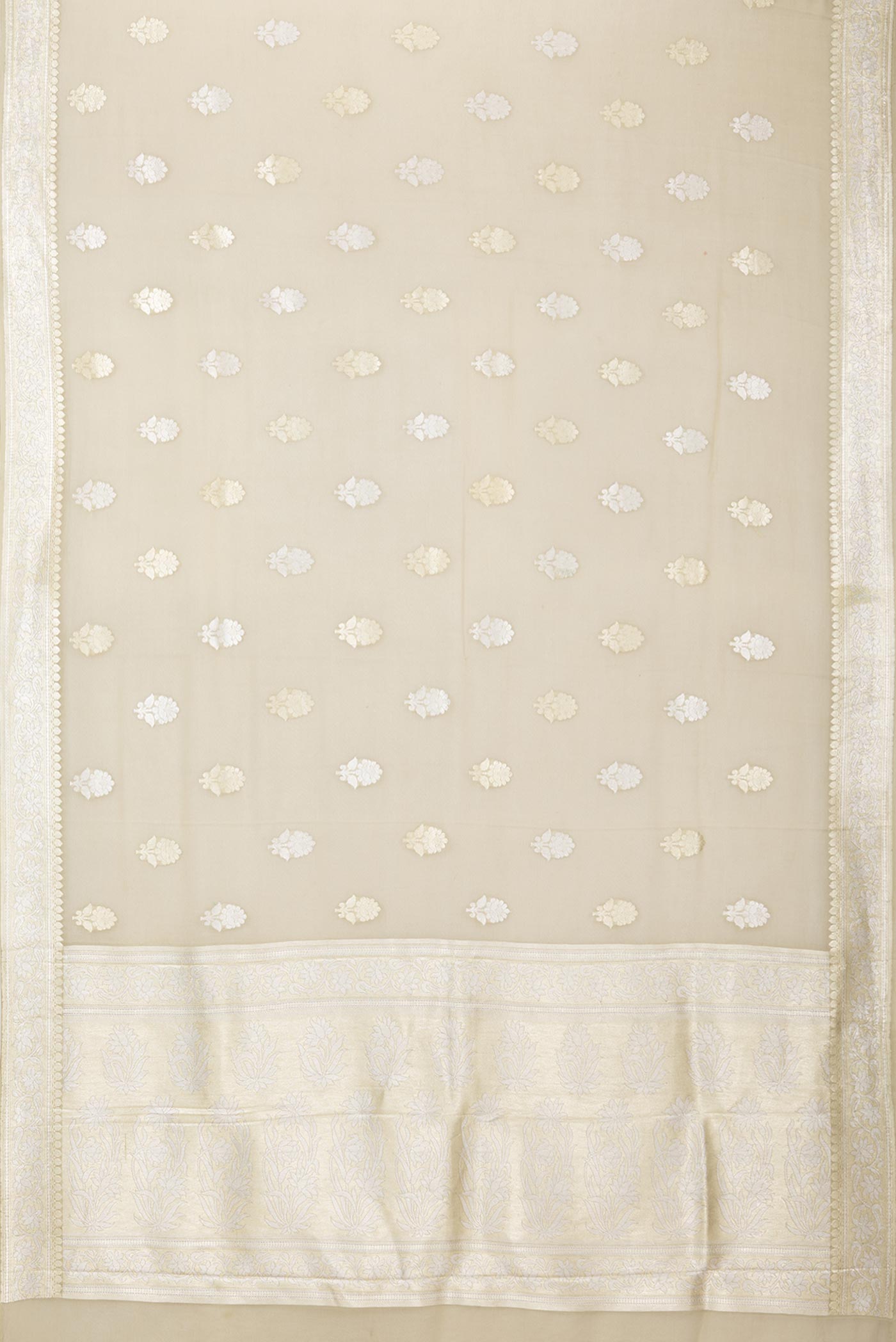 Flat view of Beige Banarasi Georgette Saree with Zari Butta on the body and Zari Border. 
