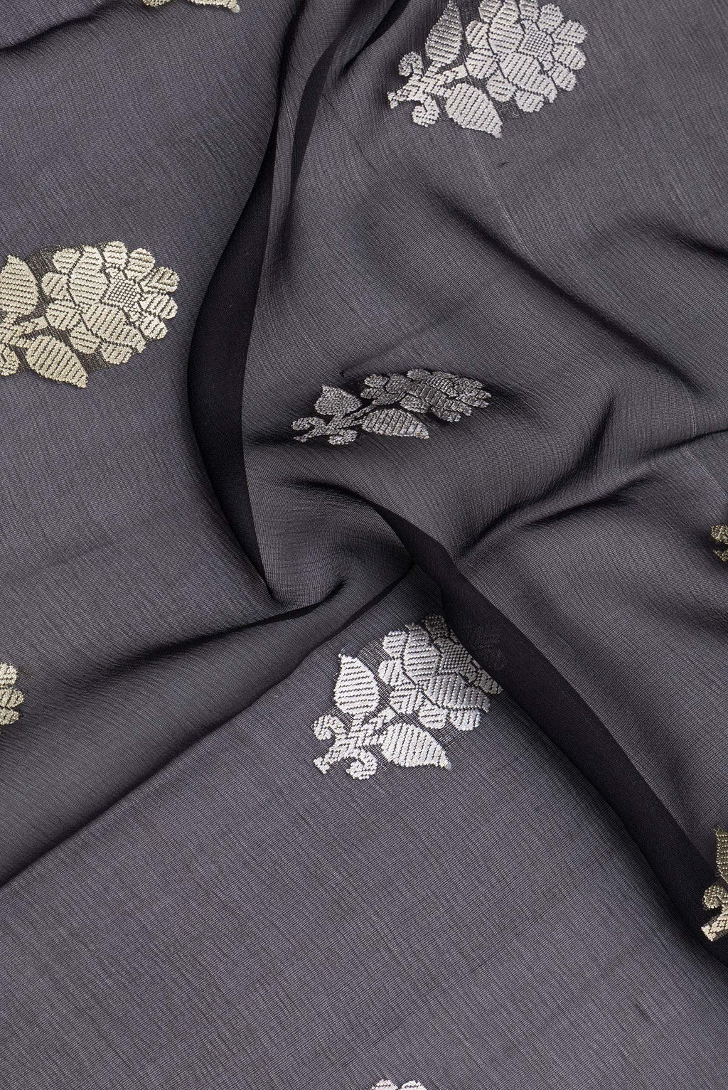 Close up of Black Banarasi Georgette Saree with Zari Butta on the body and Zari Border.  displaying folds