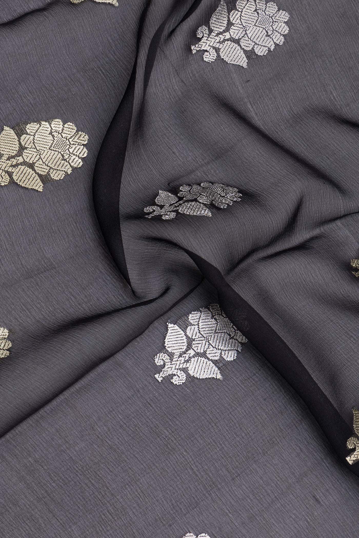 Close up of Black Banarasi Georgette Saree with Zari Butta on the body and Zari Border.  displaying folds