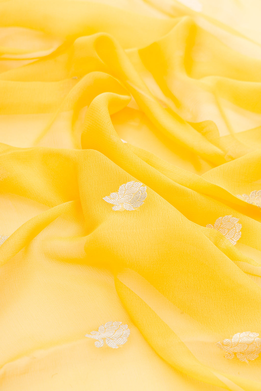 Close up of Yellow Dual Tone Banarasi Georgette Saree with Embroidery on the body and Embroidery Border.  displaying folds