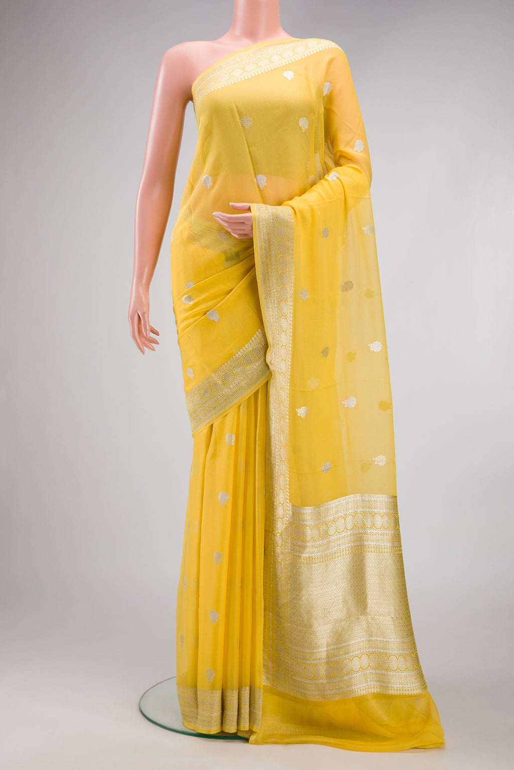 Yellow Dual Tone Banarasi Georgette Saree with Embroidery on the body and Embroidery Border.  displayed on a mannequin