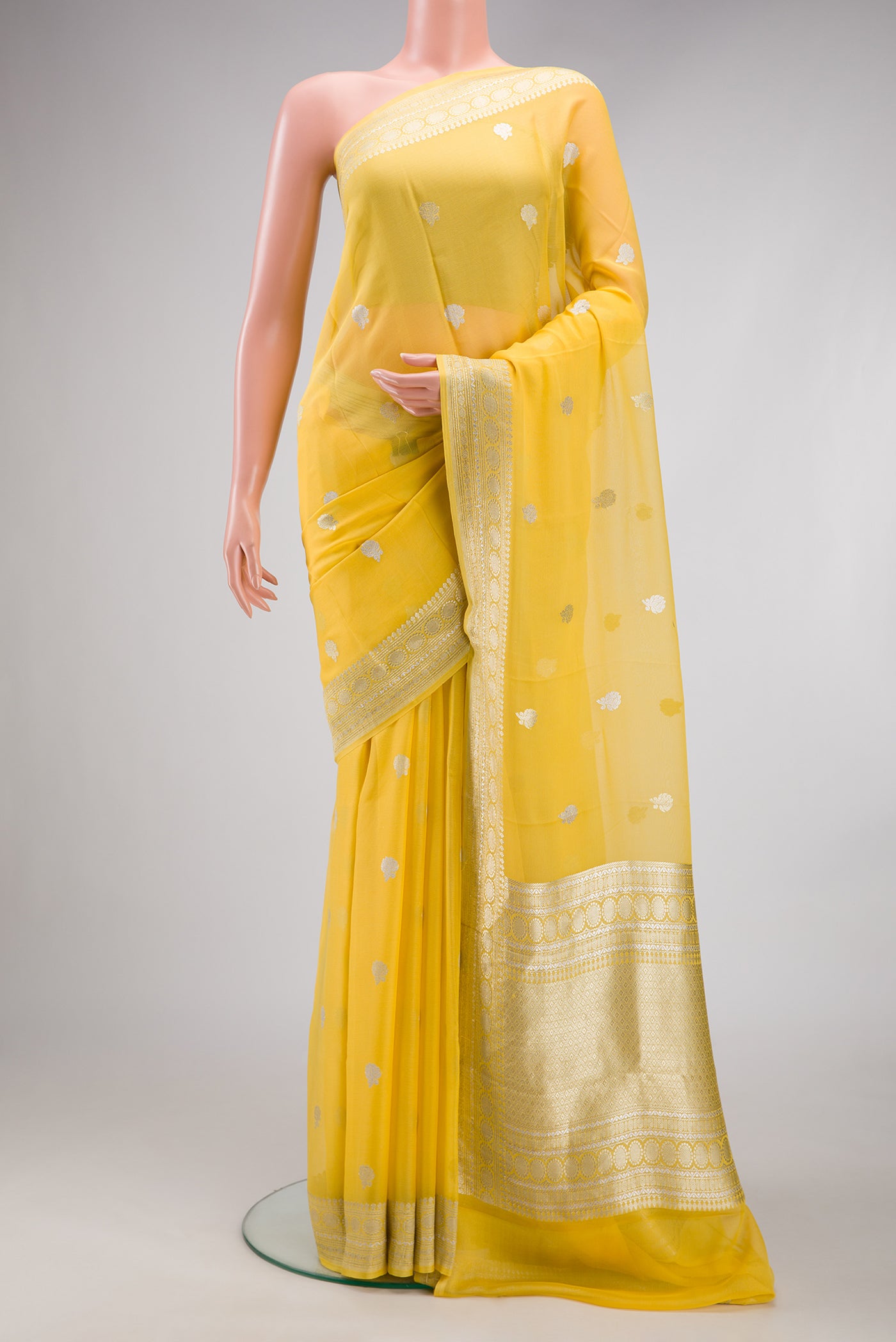 Yellow Dual Tone Banarasi Georgette Saree with Embroidery on the body and Embroidery Border.  displayed on a mannequin