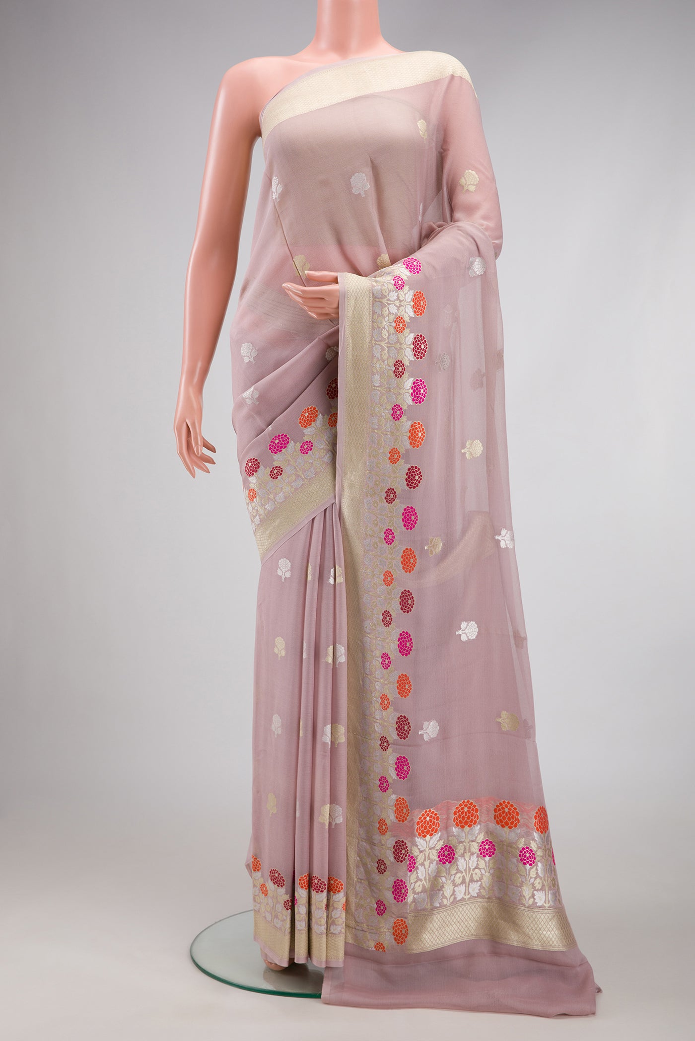 Lilac Banarasi Georgette Saree with Zari Butta on the body and Fancy Border.  displayed on a mannequin