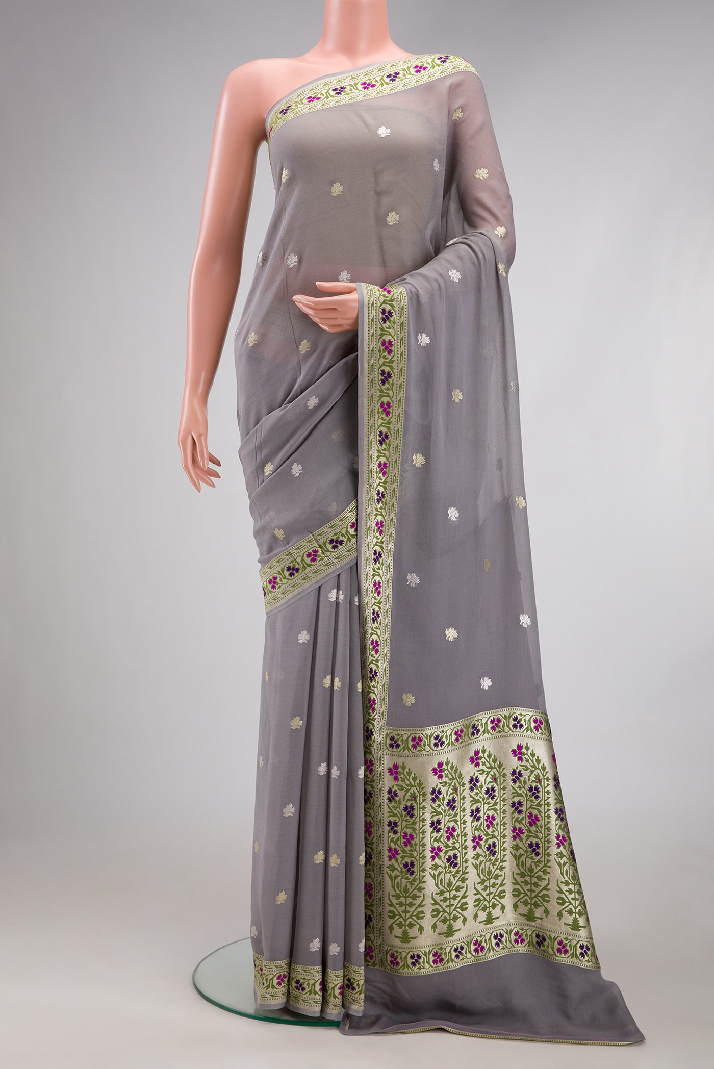Grey Banarasi Georgette Saree with Zari Butta on the body and Fancy Border.  displayed on a mannequin