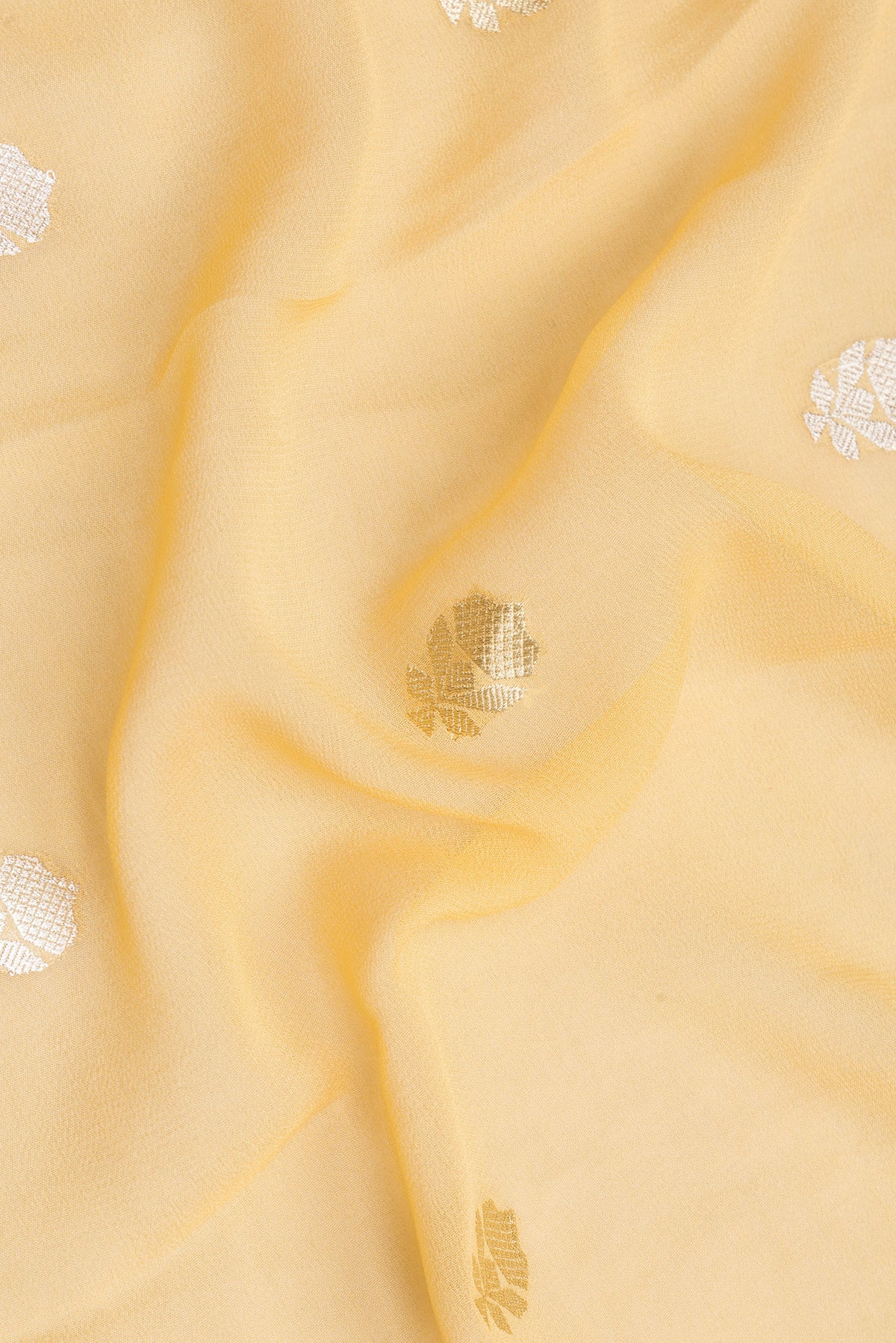 Close up of Sandal Banarasi Georgette Saree with Zari Butta on the body and Zari Border.  displaying folds