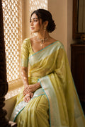 Model wearing a Pista Green Banarasi Georgette Saree with Zari Butta on the body and Fancy Border.