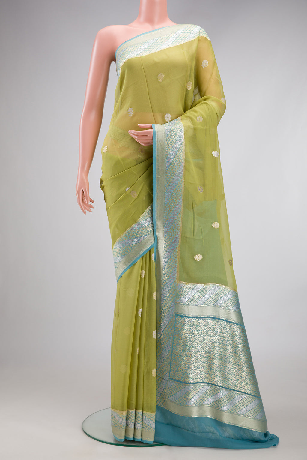 Pista Green Banarasi Georgette Saree with Zari Butta on the body and Fancy Border.  displayed on a mannequin
