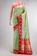 Pure Silk Pista Green Banarasi Saree with Zari Butta on the body and Fancy Border.  displayed on a mannequin